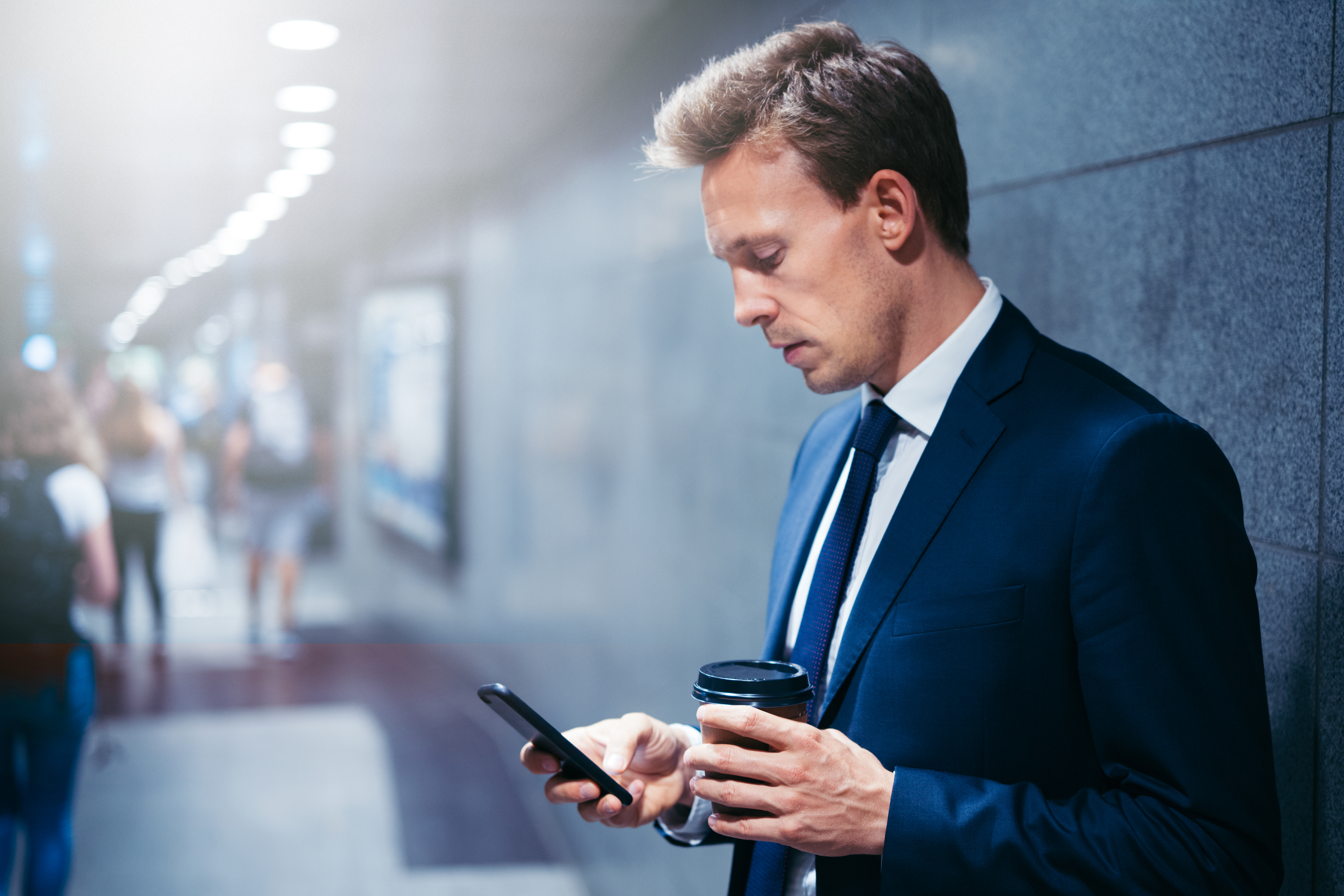 Businessman reading on the phone in the subway